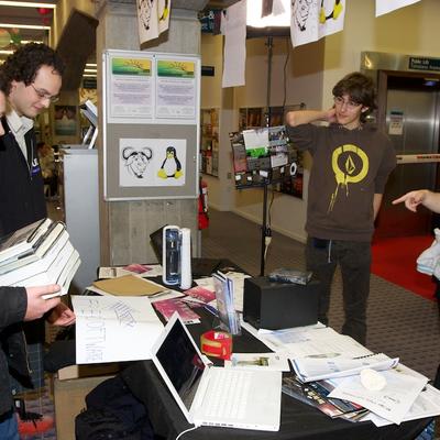Samuel (Lucid CTO aka the Tea Master) discussing the software freedom day "arrow poster".